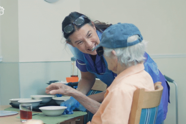 Carer chatting to care home resident
