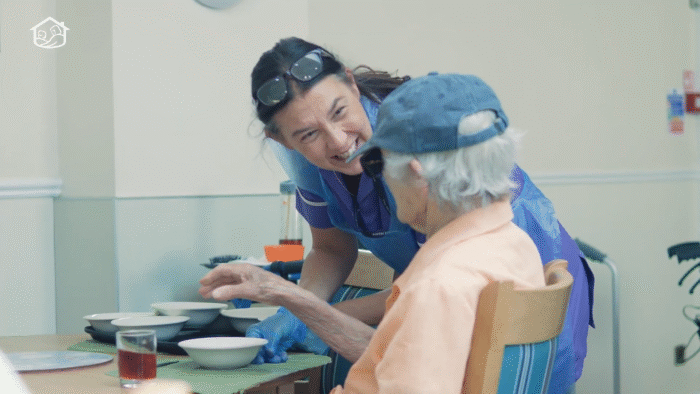 Carer chatting to care home resident