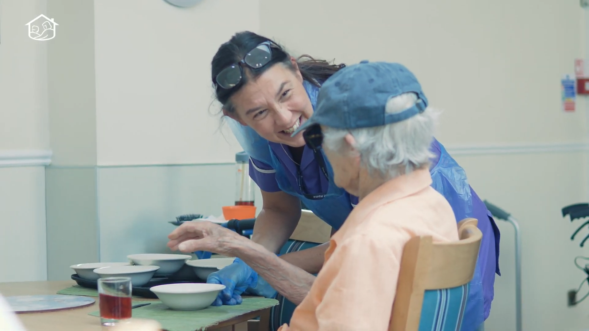Carer chatting to care home resident